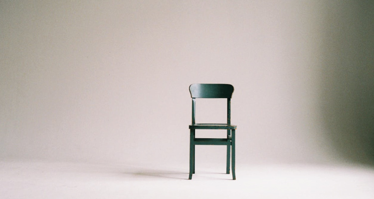 photo of one chair and nothing else in a open large space, depicting the importance of making sure your content is clear and uncluttered