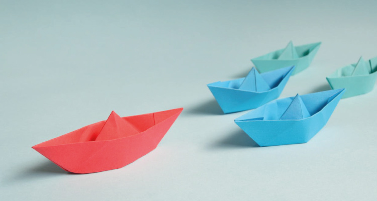 photo of a boat leading another group of boats, depicting authority content as one of the types of web content