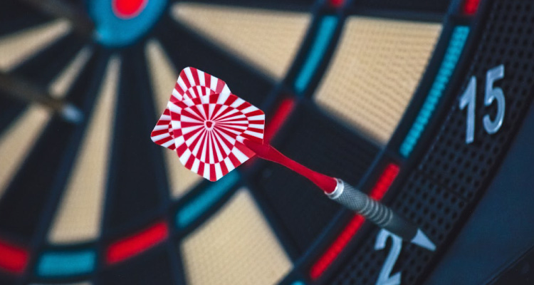 client onboarding - photo of a dart in a darts board